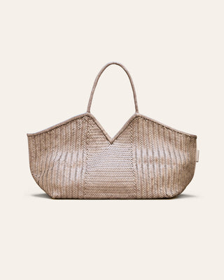 Woven leather bag on a beige background