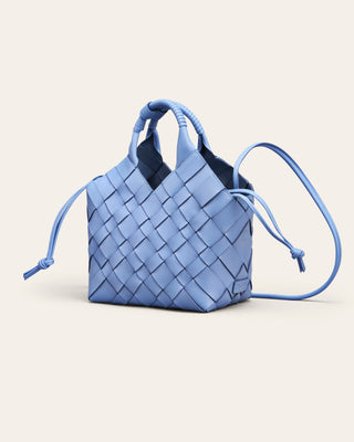 Cala Jade Misu Blue woven shoulder bags with a drawstring on a beige background
