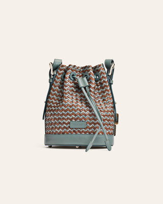 Drawstring bucket bag bag with a herringbone pattern on a light gray background