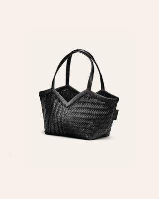 Cala Jade small black woven handbag on a beige background seen from the side