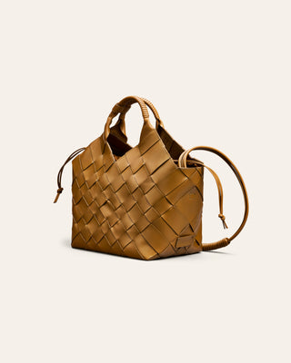 Cala Jade Woven brown handbag on a light beige background seen from the side
