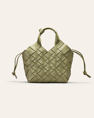 Green woven leather handbag on a light beige background