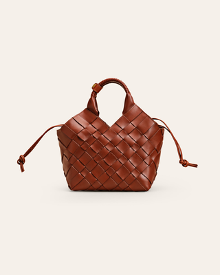 A hand braided, brown MISU nutmeg shoulder bag with a shoulder strap, a zipper closure, and a handle.