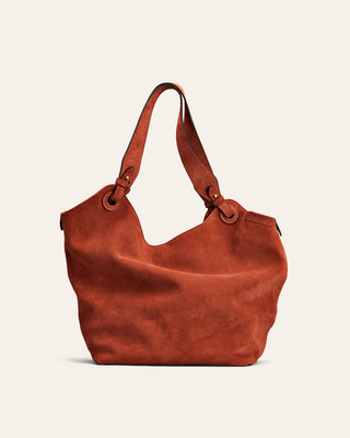 Red leather handbag on a beige background