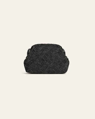 Dark green suede woven handbag on a light beige background