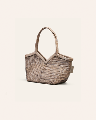 Cala Jade woven handbag with a beige strap on a light beige background
