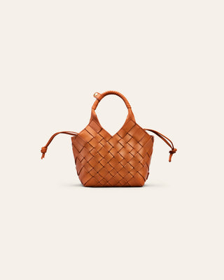 Cala Jade orange woven handbag on a light beige background
