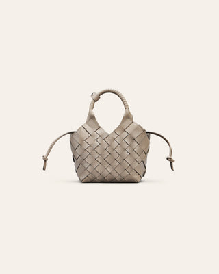 Woven handbag on a light beige background