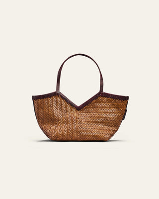 A beige and burgundy woven shoulder bag on a beige backgrpun