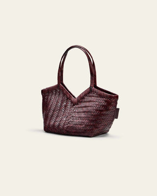 Woven handbag on a light beige background