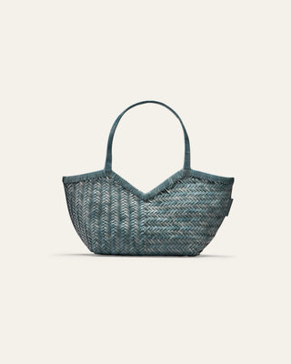 Blue woven handbag on a light beige background