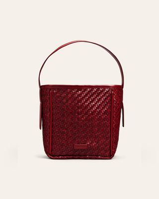 Cala Jade red woven shoulder bag on a beige background
