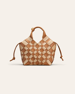 A chess patterned shoulder bag on a beige background
