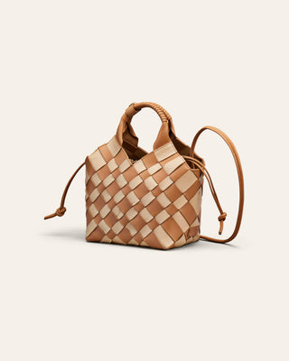 A chess patterned shoulder bag on a beige background