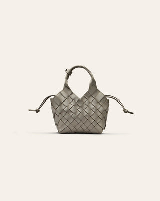 Woven handbag on a light gray background