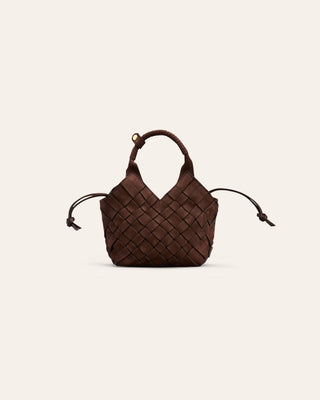 A small woven nubuck leather shoulder bag on a beige background