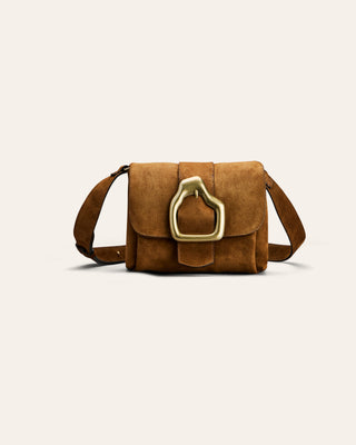 Brown suede handbag with a gold buckle on a light beige background