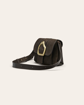 Brown suede shoulder bag with gold buckle on beige background