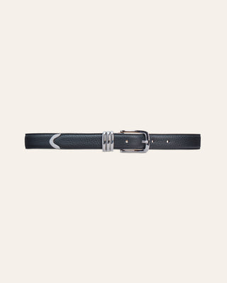 A black leather belt with silver details on a beige background